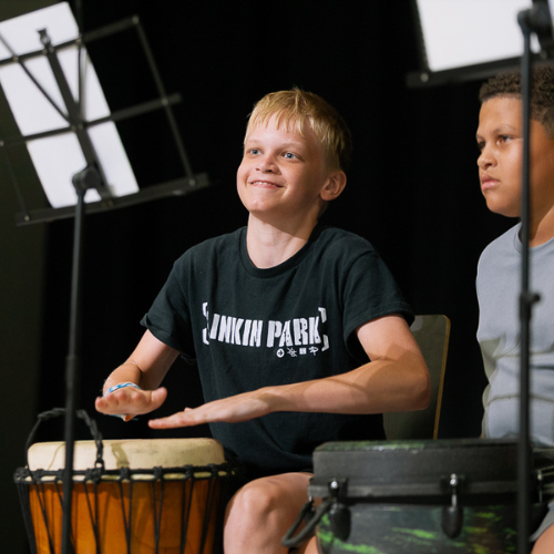 two kids playing the drums